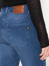 Jeans chupín de tiro medio, color azul, súper elastizado y largo hasta el tobillo.