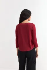 Remera de algodón color bordó con cuello bote y mangas tres cuartos.