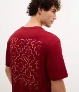 Remera de corte comfort color bordó, con cuello redondo y manga corta. Presenta una pequeña estampa gráfica de follaje con lettering en el lado izquierdo del pecho.