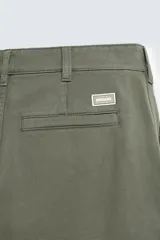 Pantalón cargo de corte recto confeccionado en tejido de algodón. Presenta bolsillos laterales con solapa en las perneras, bolsillos frontales y bolsillos traseros de vivo. Cuenta con cierre frontal de cremallera y botón.