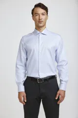 Camisa de vestir blanca de corte clásico, con cuello rígido, cierre frontal de botones y mangas largas con puños abotonados.
