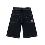Bermuda baggy de denim negro con costuras en contraste blancas, bolsillos traseros grandes y un parche bordado en forma de estrella con la inscripción 'Venefo'.