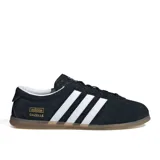Championes Adidas modelo Gazelle Lo Pro W, color negro con tres franjas laterales blancas y logo dorado. Tienen cordones negros y suela de goma color caramelo translúcida.