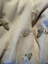 Camisa blanca de diseño clásico, con cuello camisero, mangas largas abullonadas con puños estructurados y cierre frontal abotonado.