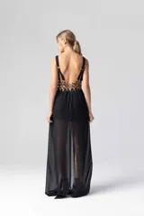 Vestido largo negro de gasa transparente con bordados dorados en el corpiño y tirantes finos.