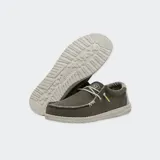 Zapatos Hey Dude modelo Wally Braided, confeccionados en tejido textil color marrón con cordones elásticos beige, costuras visibles en el empeine y suela ligera de goma.