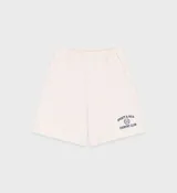 Short color crema de jersey grueso, largo medio, con cintura con cordón, bolsillos delanteros y un bolsillo trasero. Estampado frontal con el logo de la marca.