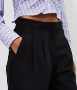 Pantalón pantacourt negro de sarga con largo midi y caída estructurada, cuenta con cintura de terminación limpia y pinzas frontales.