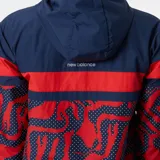 Campera deportiva New Balance con capucha, color azul marino con detalles en rojo y estampado con lunares blancos.