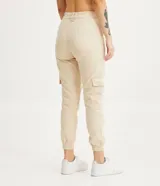 Pantalón jogger color beige, de tiro alto, con bolsillos cargo laterales y tobillos ajustados.