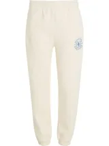 Pantalón de jogging color crema, con cintura elástica y cordón ajustable. Presenta un logo circular con el monograma TH bordado en azul en el muslo.