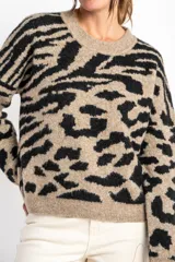 Sweater de lana color beige con estampado animal print en negro.