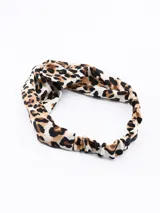 Vincha con estampado animal print de leopardo, con nudo superior y elástico en la parte posterior.
