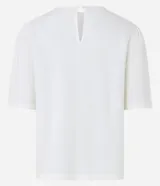 Blusa de viscolino color amarillo pálido, con cuello redondo y mangas cortas abullonadas.