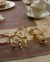 Anillo dorado con diseño irregular que simula un pétalo.