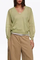 Jersey de punto verde claro con escote en V pronunciado, mangas largas y corte recto, confeccionado en mezcla de viscosa y poliéster.