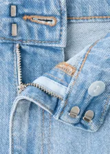 Pantalón de jean de tiro medio y diseño wide leg con bolsillos de solapa delanteros, trabillas para cinto y cierre con gancho y cremallera.