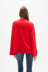 Sweater de viscosa color rojo, con cuello polera, corte holgado y pespuntes decorativos.