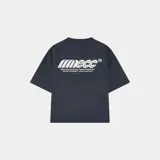 Camiseta azul marino de corte "boxy fit" con estampado blanco en la espalda que dice "Emecc" y texto adicional "DESIGN TEAM SELECTIONS / TABARCA BOATERS 2025 BUILDING A COMMUNITY THROUGH GRATITUDE".
