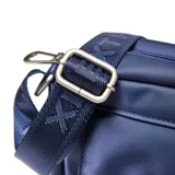 Bandolera de diseño rectangular en color azul, confeccionada en material textil. Presenta un compartimento frontal con solapa, cierre de hebilla metálica a presión y detalle de placa metálica cuadrada. Incluye correa ajustable con logo grabado y herrajes metálicos.