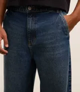 Pantalón baggy de jean azul, con bolsillos delanteros tipo cuchillo y bolsillos traseros.