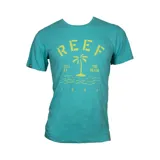 Remera de algodón color turquesa con estampa frontal en color amarillo que incluye el logo de la marca, una palmera y el texto 'Still at the beach 1984'.