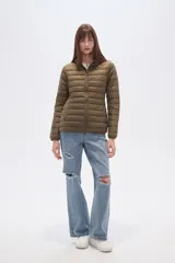 Campera acolchada tipo puffer, color beige claro, con capucha y cierre frontal. Presenta costuras horizontales y un calce entallado.