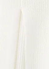 Chaleco de punto blanco de cuello alto y diseño recto, confeccionado con mezcla de acrílico, poliéster, poliamida y lana.