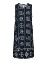 Vestido midi sin mangas de viscosa y lino con estampado floral blanco sobre fondo azul marino y cuello camisero.