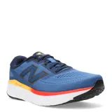 Championes New Balance Running eVOZ, color azul con detalles en rojo, amarillo y negro.