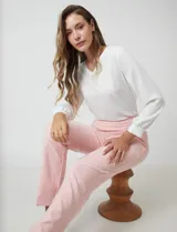 Pantalón sastrero de corte slim, color blanco, con pretina anatómica y panel interno modelador. Presenta bolsillos laterales tipo ojal, bolsillos traseros simulados y nervadura vertical marcada en el frente.