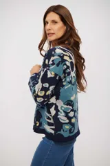 Buzo de tejido de punto con diseño estampado abstracto en tonos azul marino, celeste y amarillo. Presenta cuello redondo, mangas largas y terminaciones en tejido acanalado.