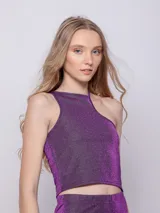 Top asimétrico de tela brillante color azul, sin mangas.