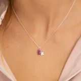 Collar de plata 925 con cadena de 40 cm más 5 cm de extensión. Incluye dos colgantes: una estrella de topacios blancos y una gota de rubí.