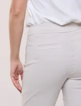 Pantalón de gabardina elastizada color beige, de tiro medio y calce slim. Cuenta con diseño pull-on sin cierres ni botones, cintura ancha, bolsillos delanteros simulados y bolsillos traseros ojal.