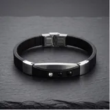 Pulsera de diseño moderno compuesta por una banda de goma negra con detalles metálicos en acero inoxidable y tres apliques circulares decorativos.