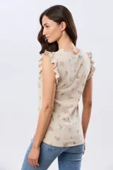 Remera blanca de algodón con delicado estampado floral y volados en las mangas cortas, con diseño de cuello redondo.