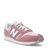 Championes urbanos New Balance modelo 373, color rosado con detalles en blanco y gris. Confeccionados en una combinación de gamuza y malla, presentan el logo 'N' característico en los laterales y una suela de goma resistente.