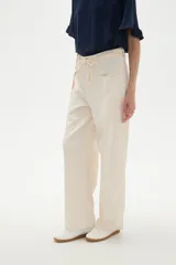 Pantalon de jean color natural, de corte baggy con cintura media, bolsillos laterales amplios y ajuste mediante cordón en la cintura.