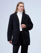 Cárdigan largo reversible color blanco. Un lado es de sherpa y el otro capitoneado. Tiene bolsillos delanteros.