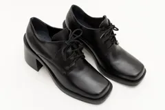 Zapato acordonado de cuero color marrón chocolate, con punta cuadrada y tacón ancho.