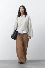 Sweater de tejido de punto con hilo metalizado, color marrón, con cuello redondo y mangas largas abullonadas con puños ajustados.