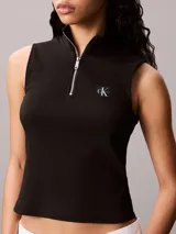 Remera sin mangas de corte slim, confeccionada en punto de canalé fino. Presenta cuello perkins con cierre frontal de cremallera y etiqueta tejida con el logo monograma de la marca en el bajo.