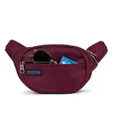 Riñonera Jansport modelo Fifth Avenue, color verde menta, con cierre principal y bolsillo frontal con cierre. Incluye parche con logo de la marca en el frente.