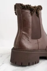 Bota Chelsea de cuero marrón con elástico lateral y suela track. Interior forrado en corderito.