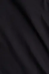 Remera negra de manga larga, entallada, con escote cuadrado pronunciado.