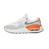 Championes Nike Air Max Systm de diseño deportivo, color blanco con detalles en gris claro, negro y verde neón. Presentan el logo de la marca en negro en el lateral y una unidad de aire visible en el talón con marco verde neón.
