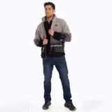 Campera polar de hombre con cierre frontal, cuello alto y bolsillos laterales. Diseño con estampado de montañas en tonos grises y negros.