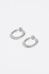 Caravanas de aro con acabado metálico dorado y cierre de presión. Presentan el logo de la marca Bimba y Lola grabado en el lateral.