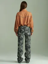 Camisa negra de algodón con mangas largas, cuello camisero y detalles de ribetes estampados a cuadros en los hombros, puños y aberturas de botones.